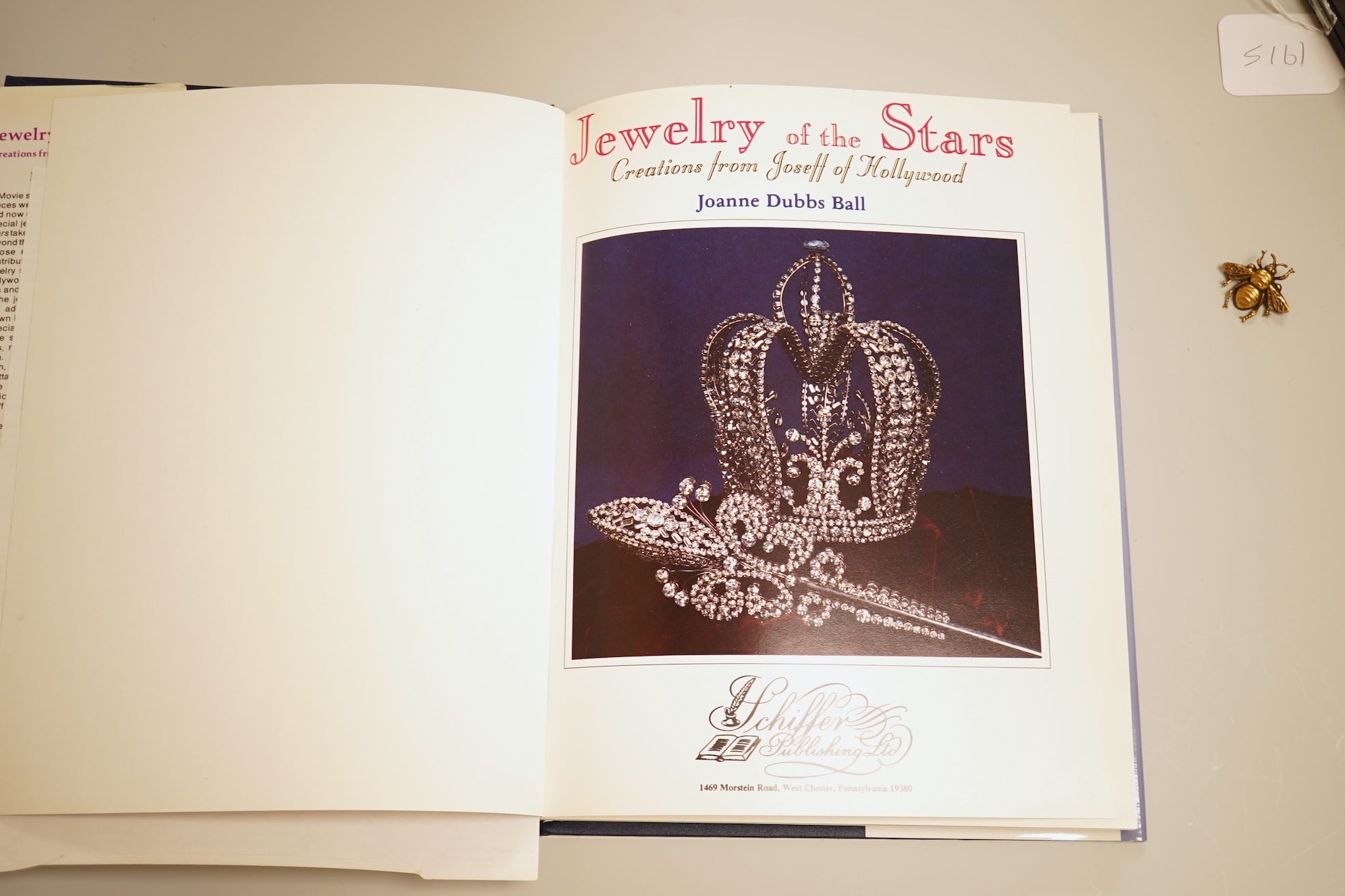 A mid 20th century North American gilt metal bee brooch by Joseff, wing span 30mm, together with a hard back copy of 'Jewelry of the Stars, Creations from Joseff of Hollywood' by Joanne Dubbs Ball.